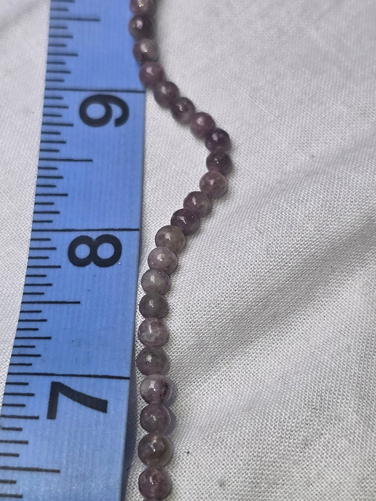 Purple lepidolite round beads closeup