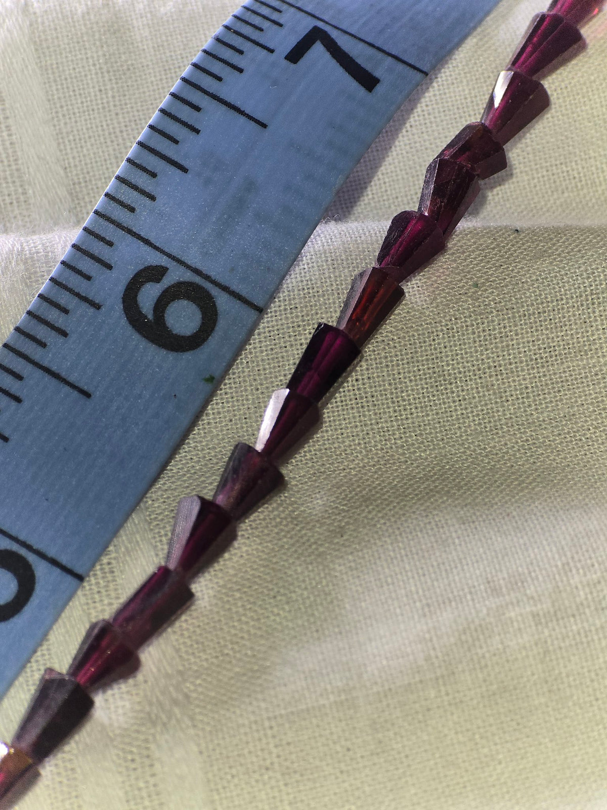 Dark purple faceted cone beads closeup 2