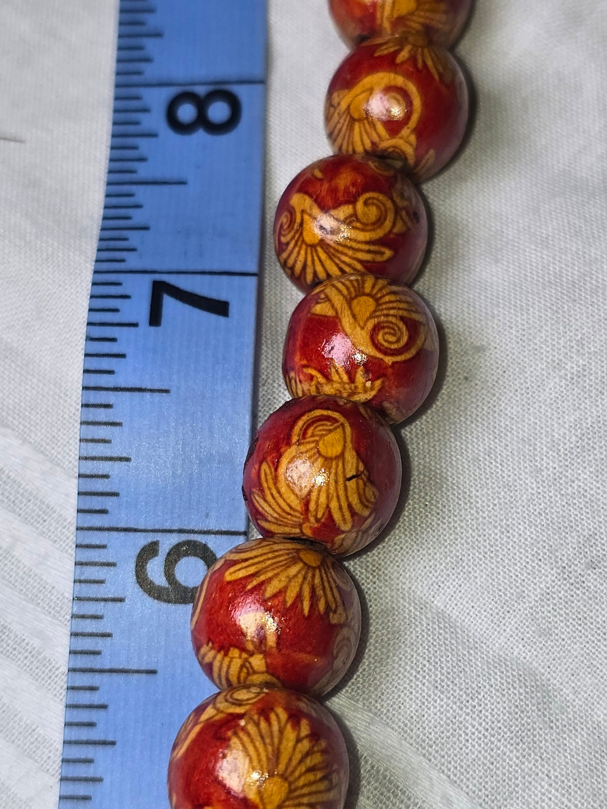 Red painted wood beads closeup