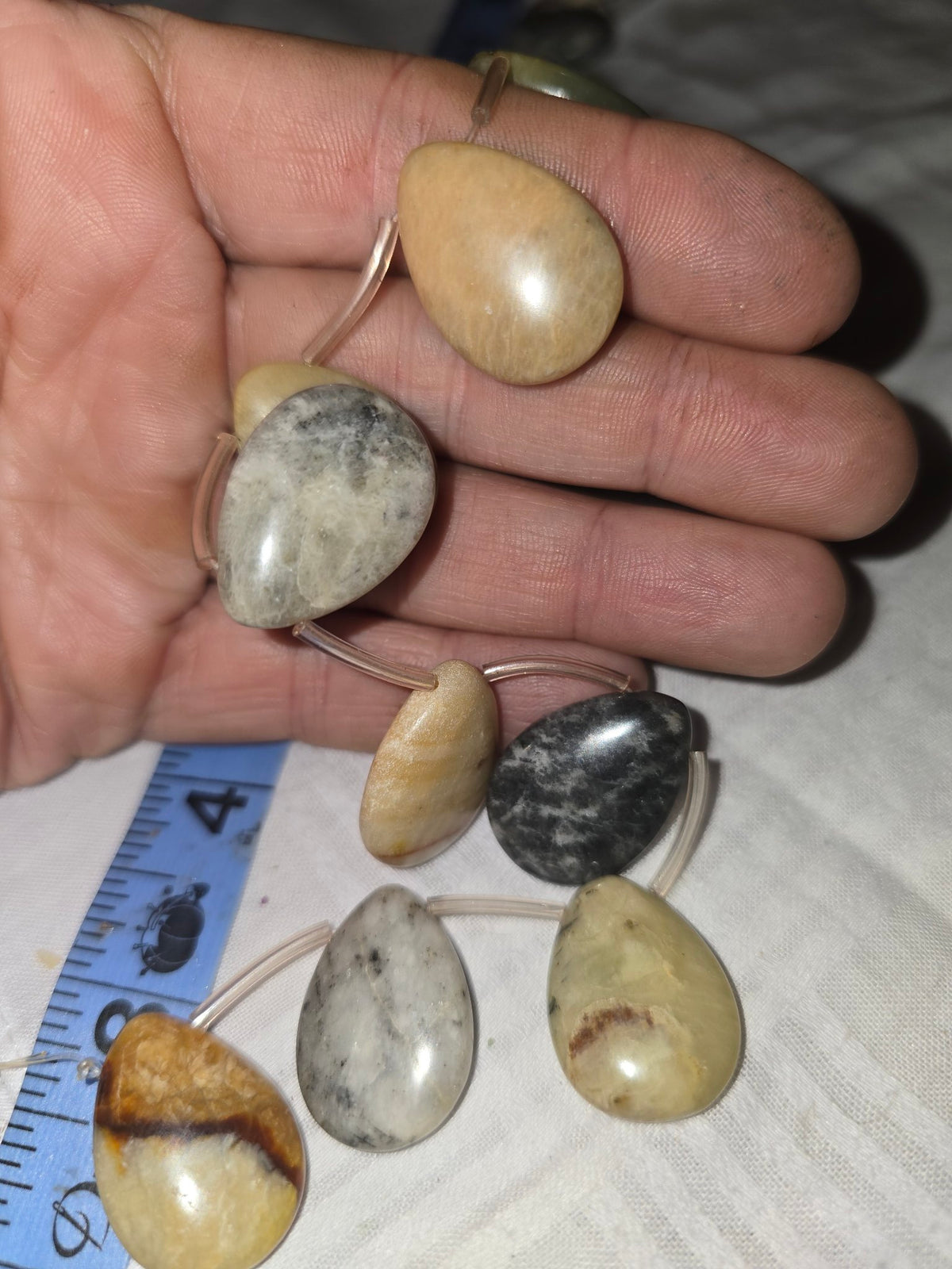 Mixed jasper teardrop beads in hand