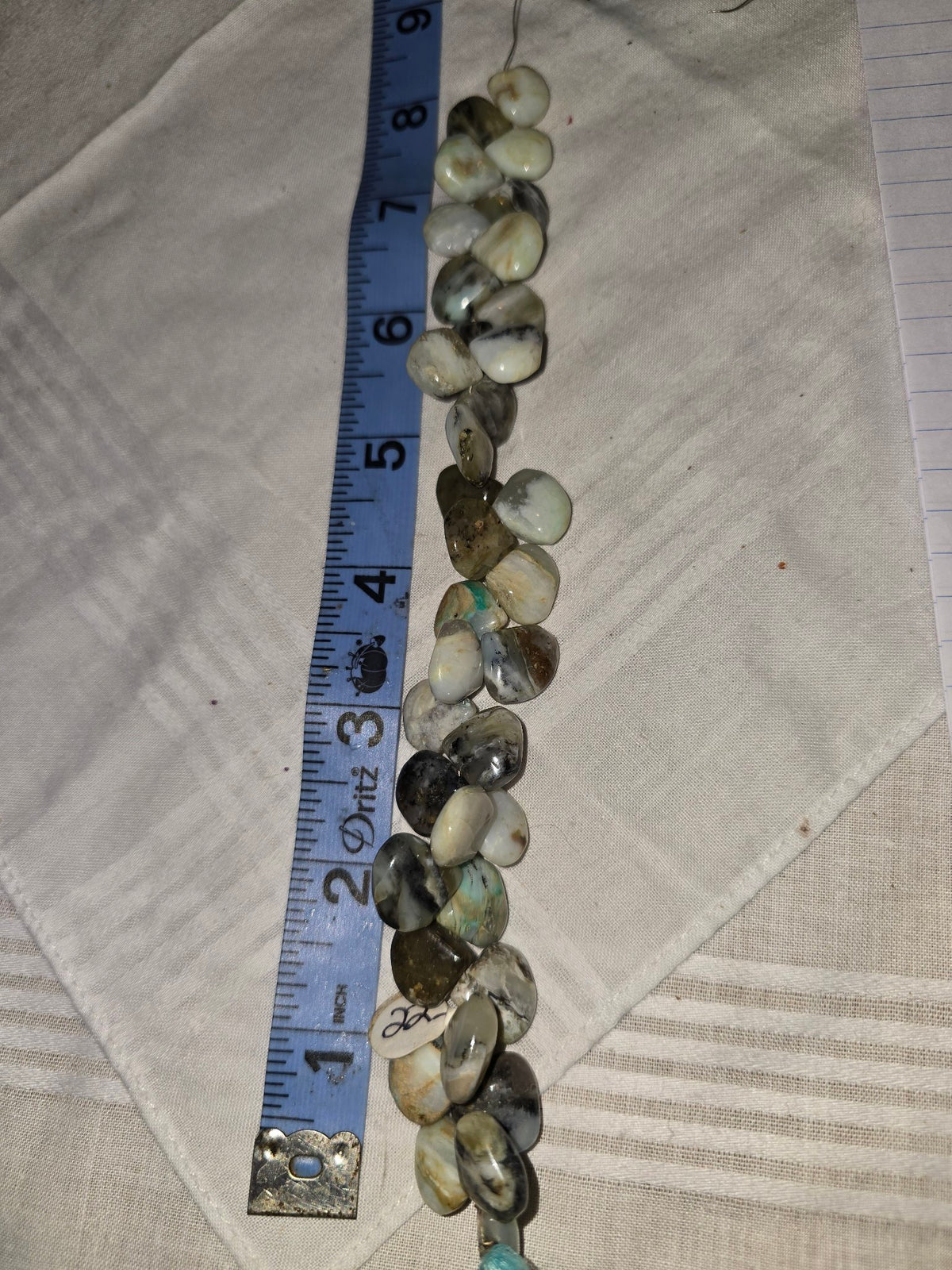 White mottled opal teardrop bead strand