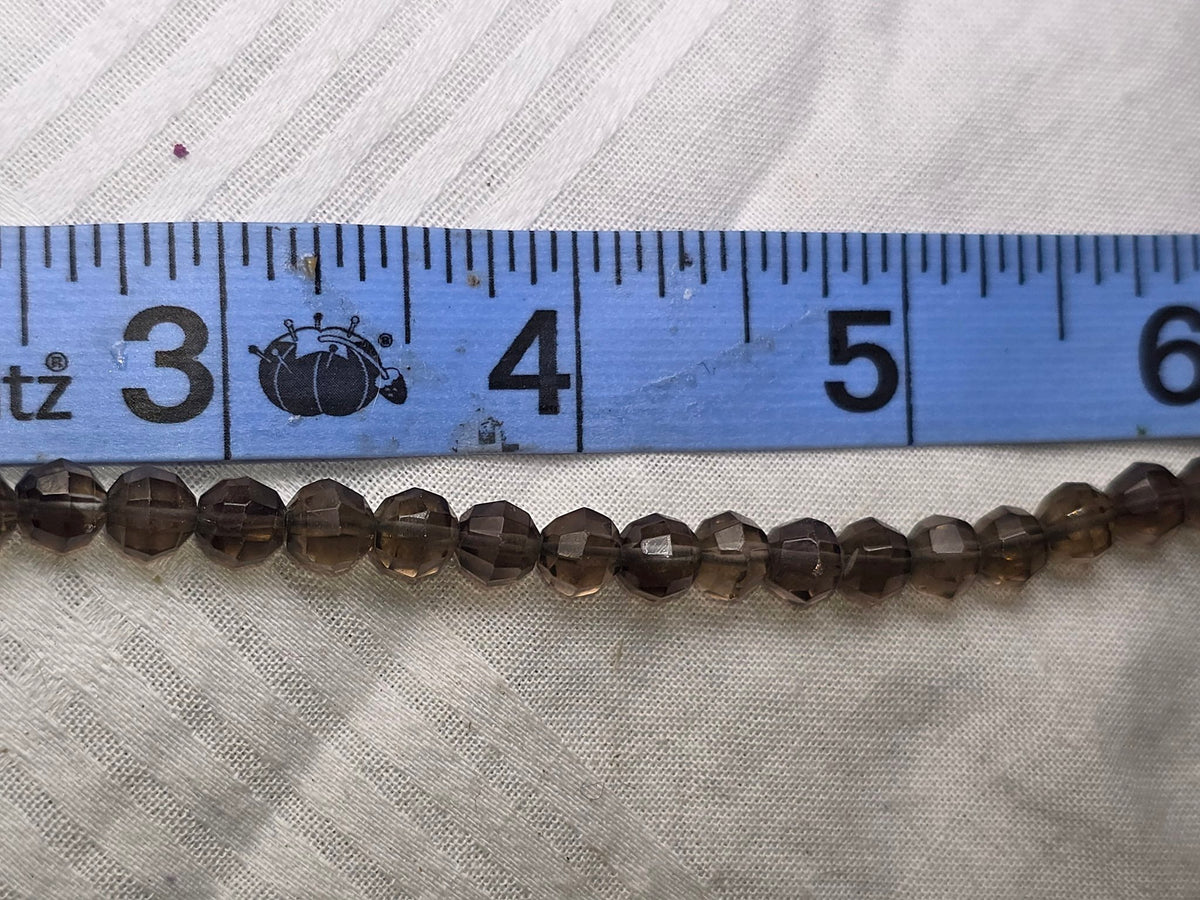 Smoky quartz faceted round bead strand closeup