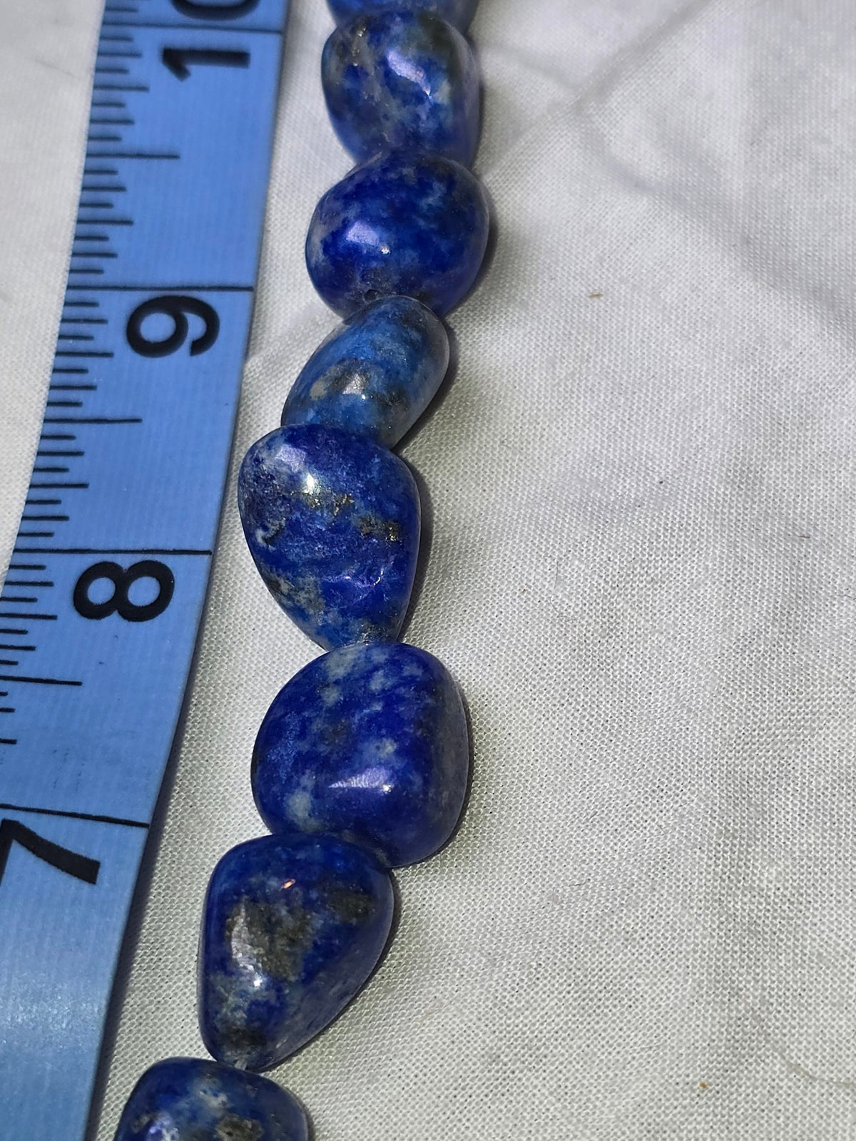 Lapis lazuli oval bead strand closeup 2