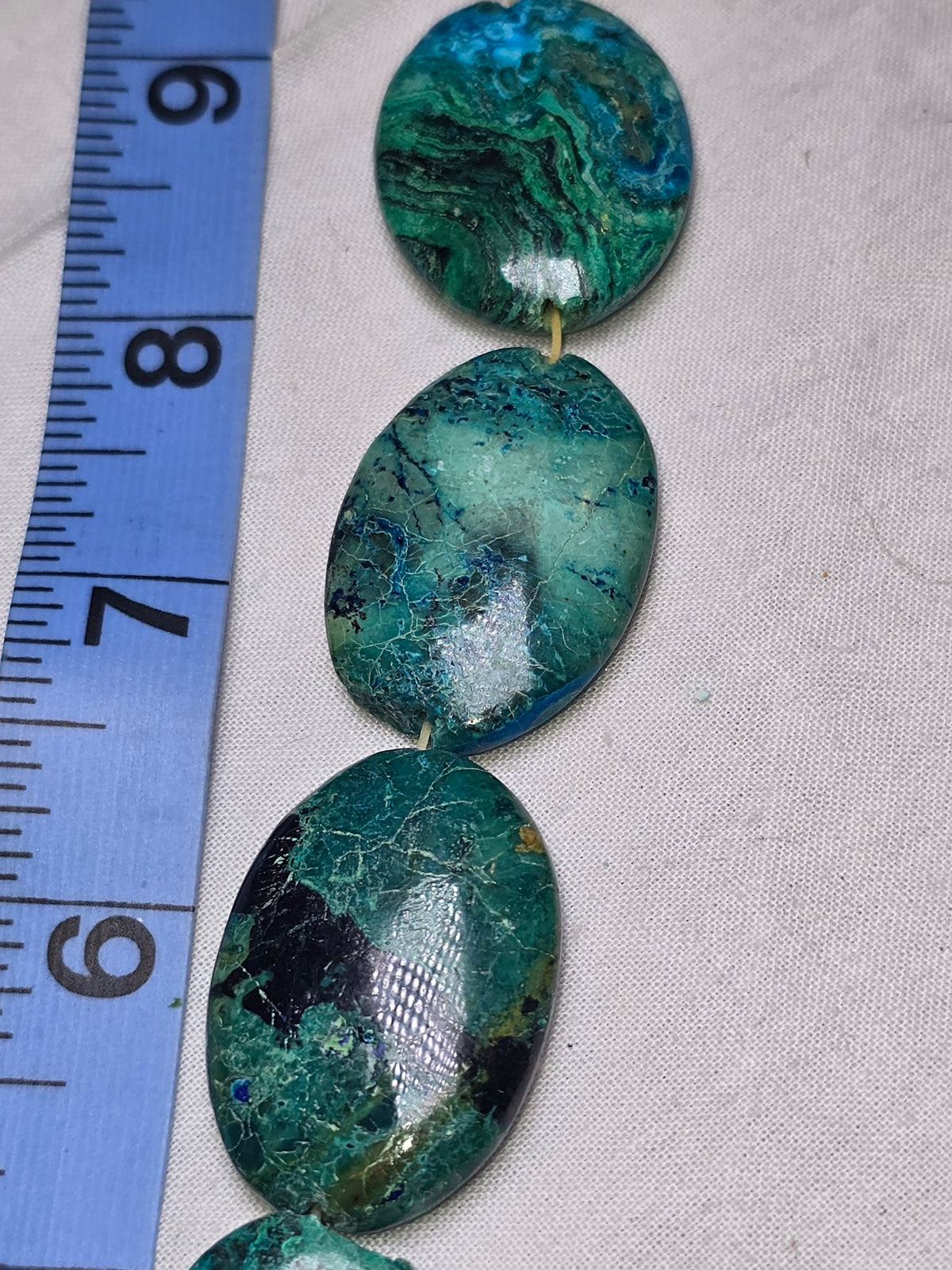Chrysocolla in lapis flat oval closeup