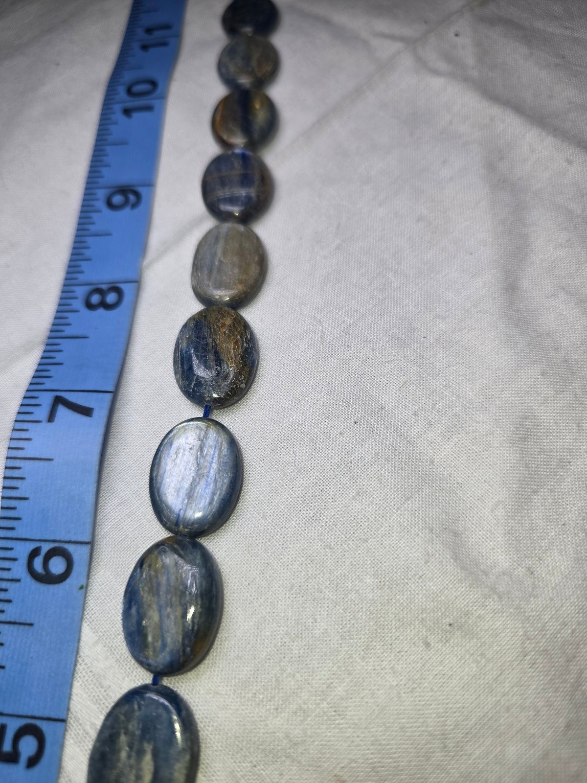 Lapis with gold oval bead strand closeup