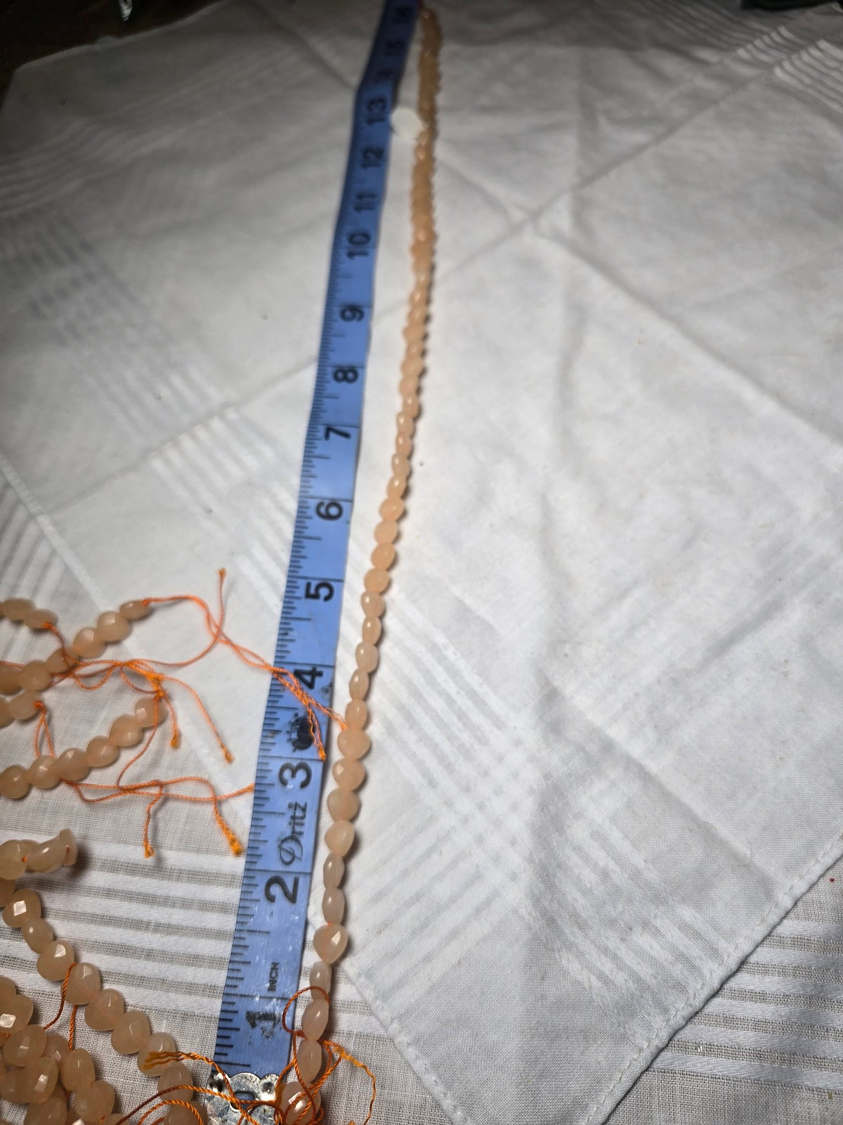Pale peach oval bead strand
