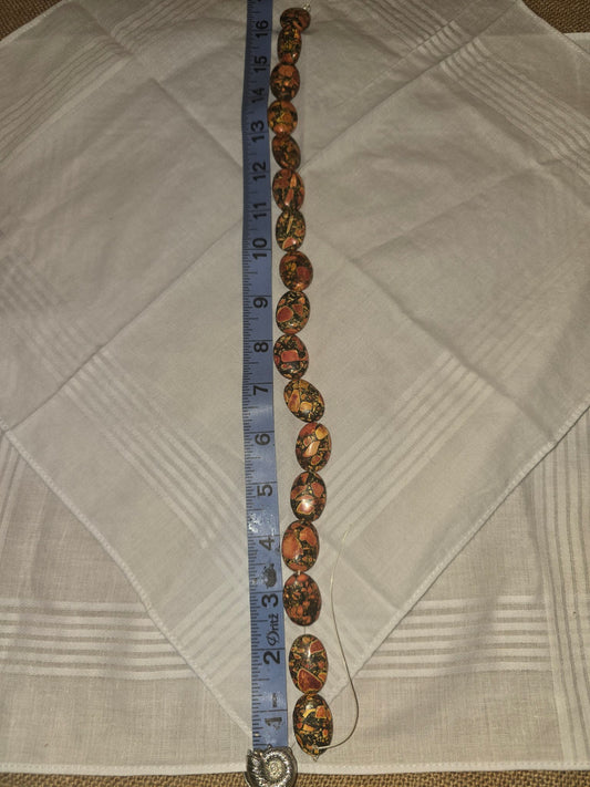Picasso Jasper oval bead strand, orange black mosaic, 17 beads, 16 inches, with ruler for scale