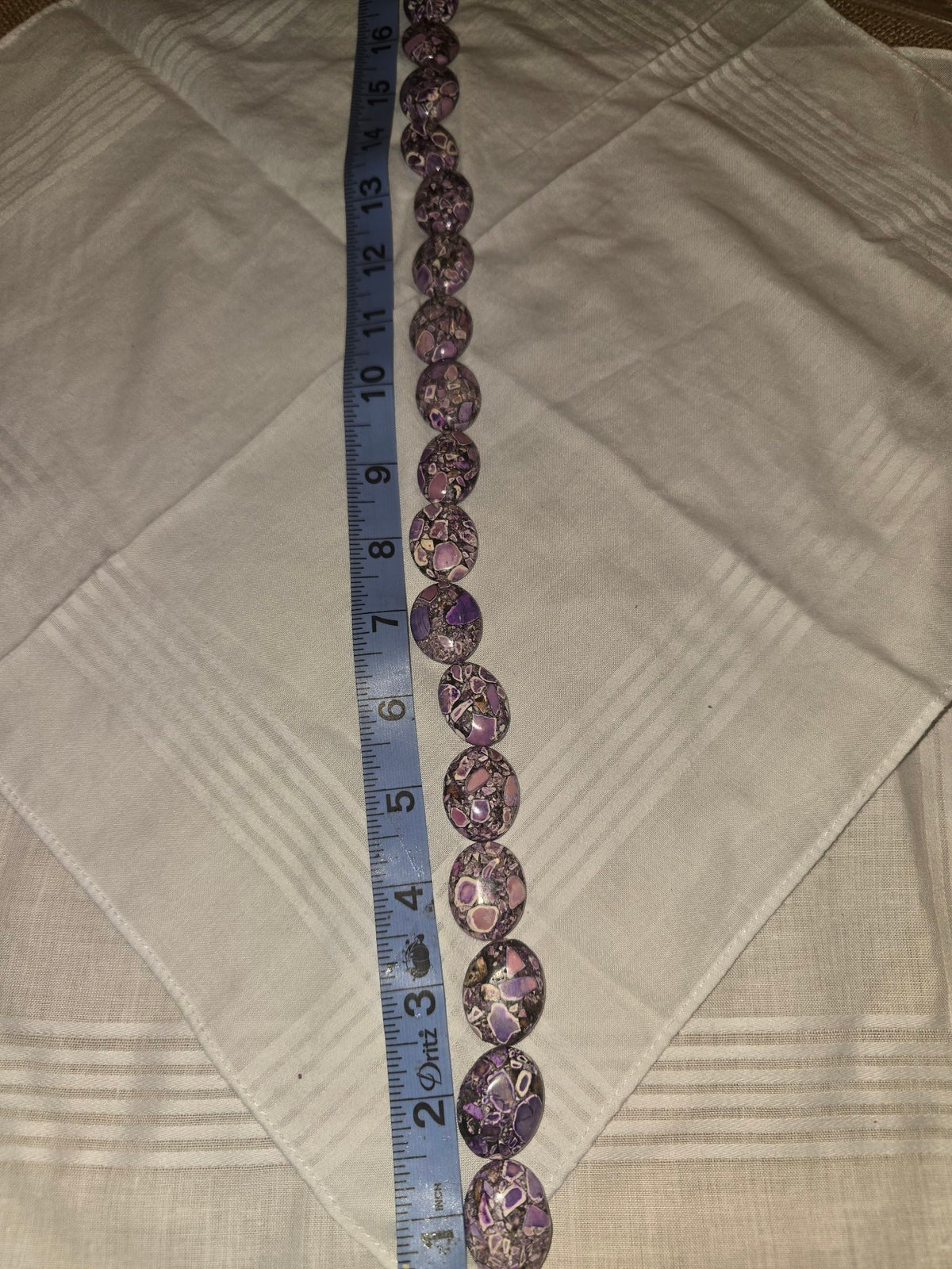 Picasso Jasper oval bead strand, purple mosaic, 17 beads, 16 inches, with ruler for scale