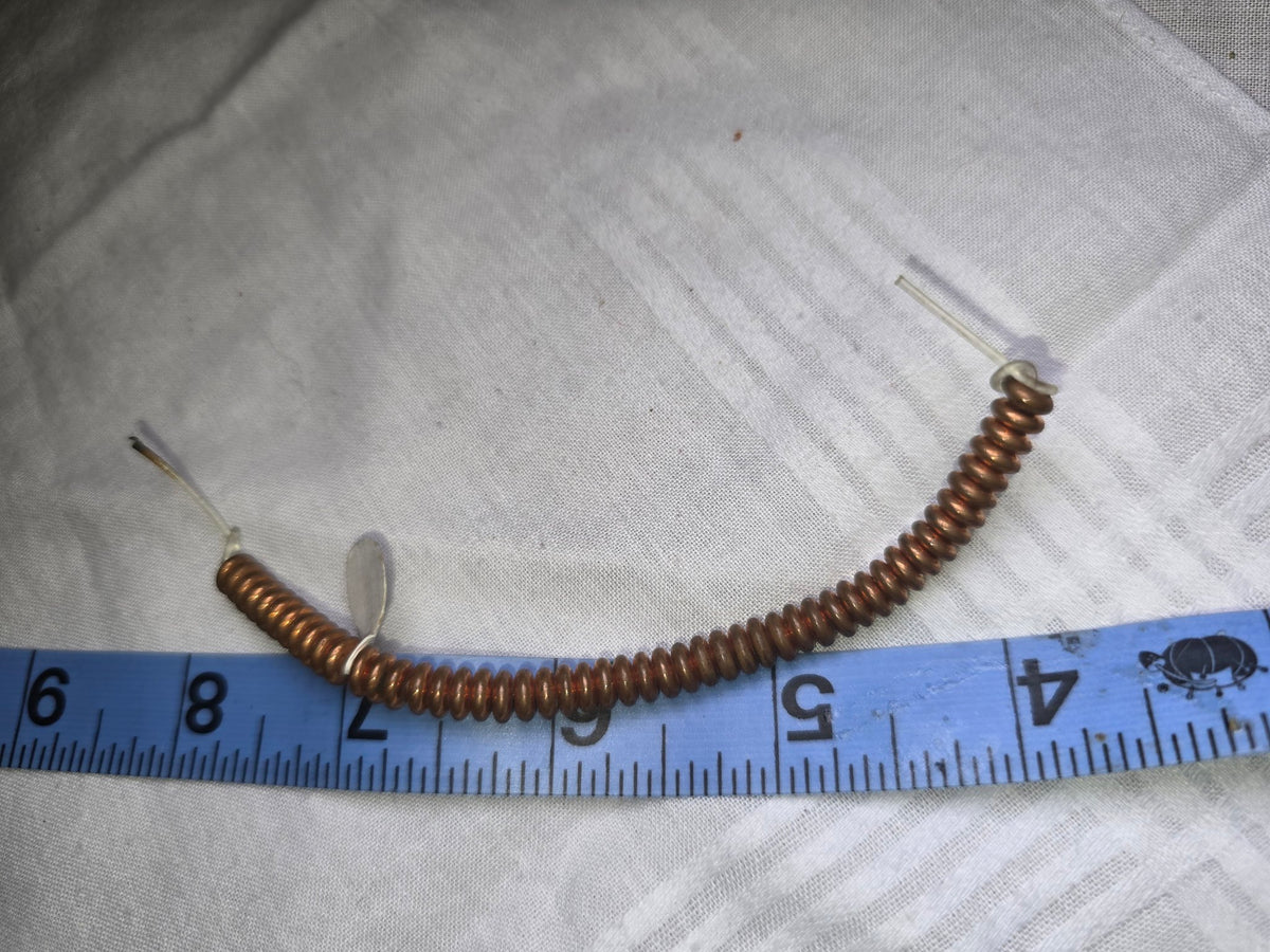 Copper disc bead strand with ruler for scale