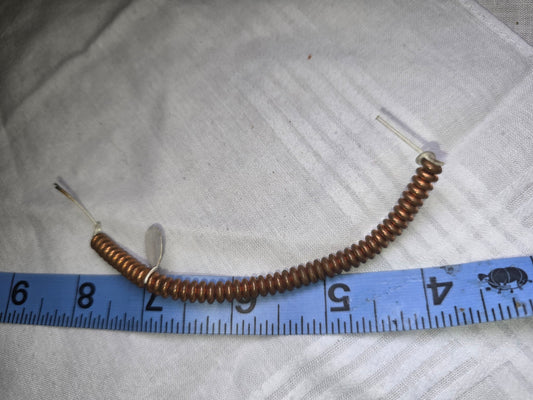 Copper disc bead strand with ruler for scale