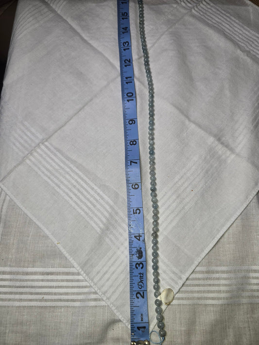 Aquamarine round bead strand with ruler for scale