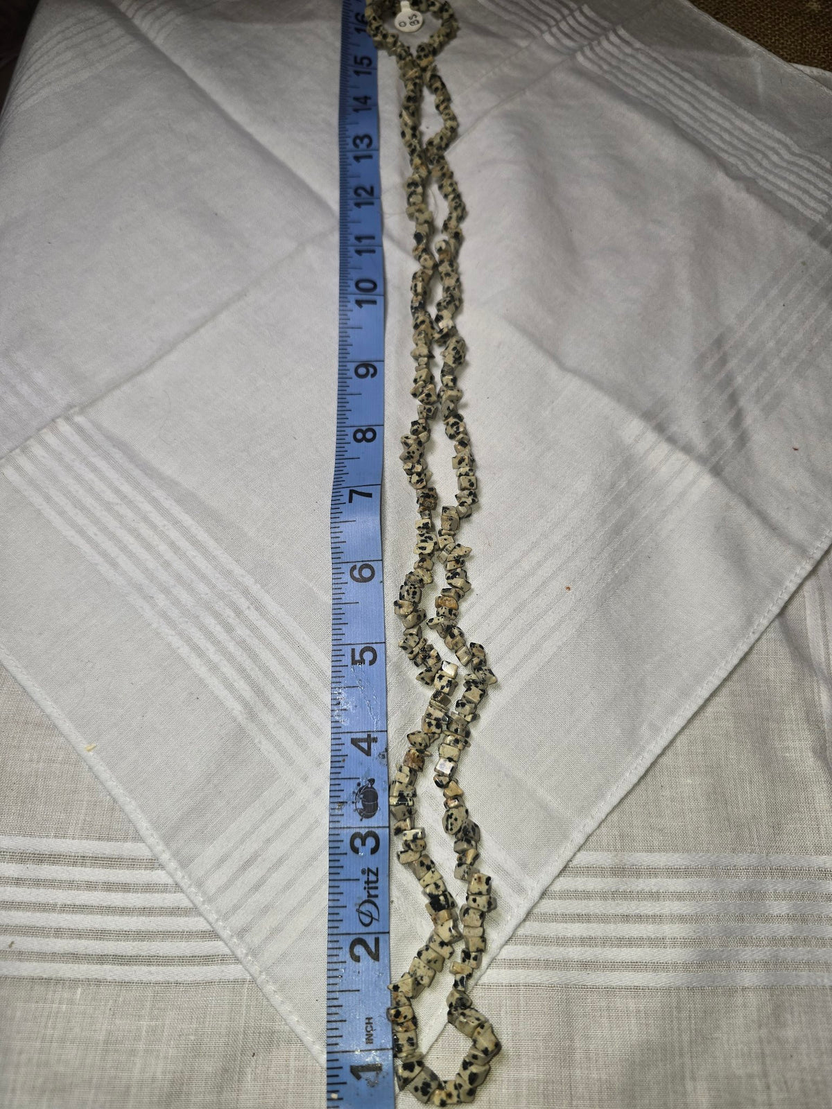 Dalmatian jasper chip bead strand doubled with ruler
