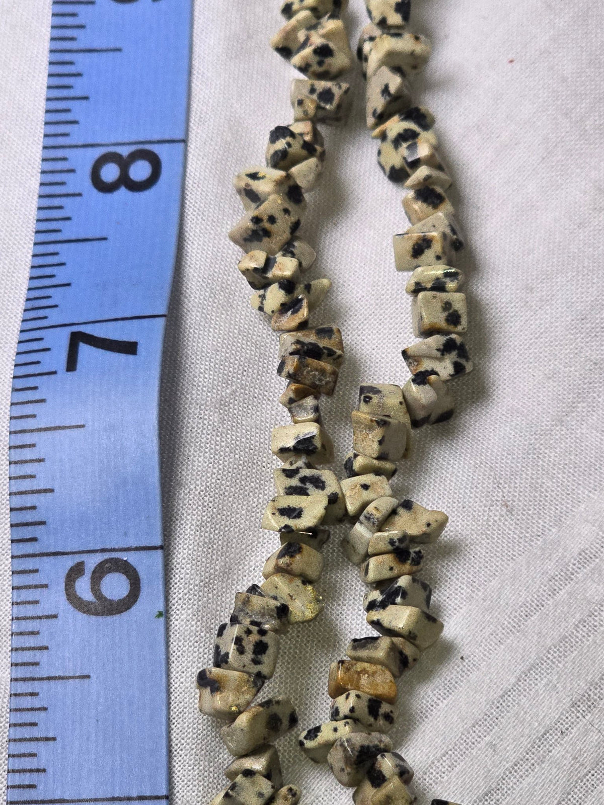 Closeup of dalmatian jasper chip beads