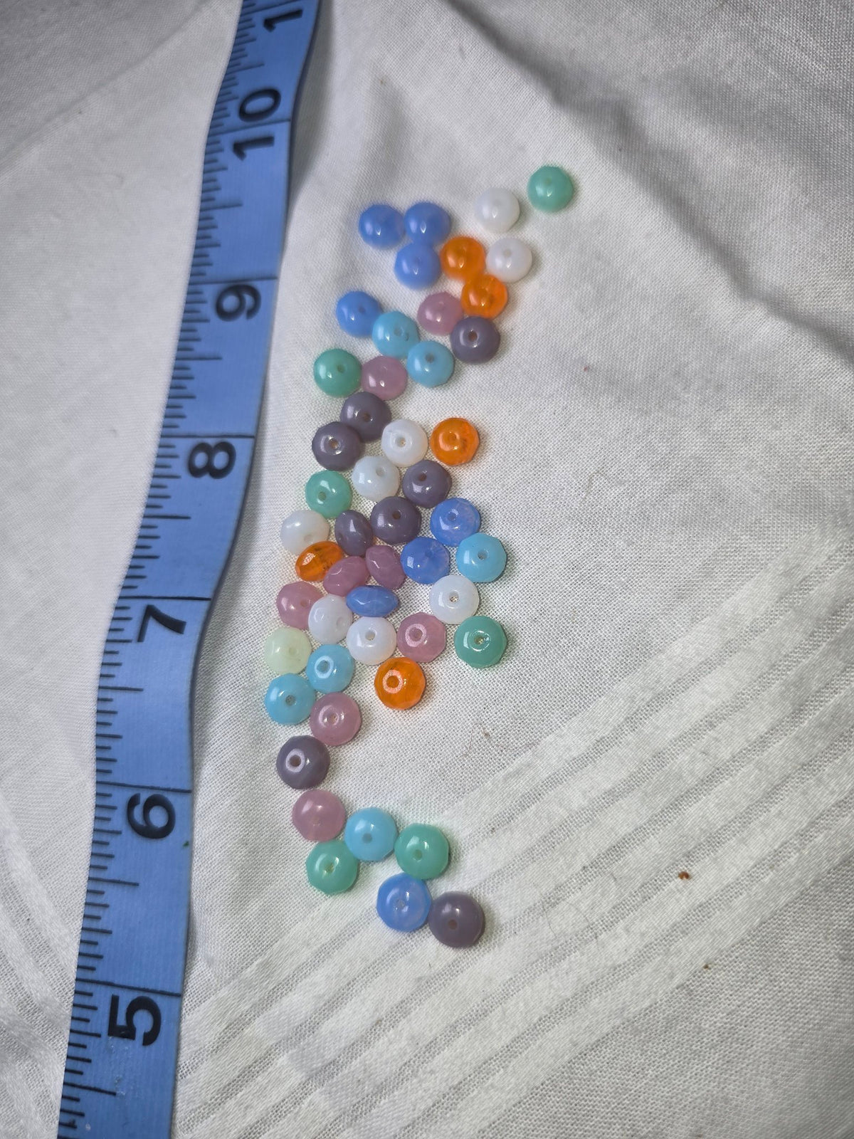 Mixed pastel glass rondelle beads with ruler