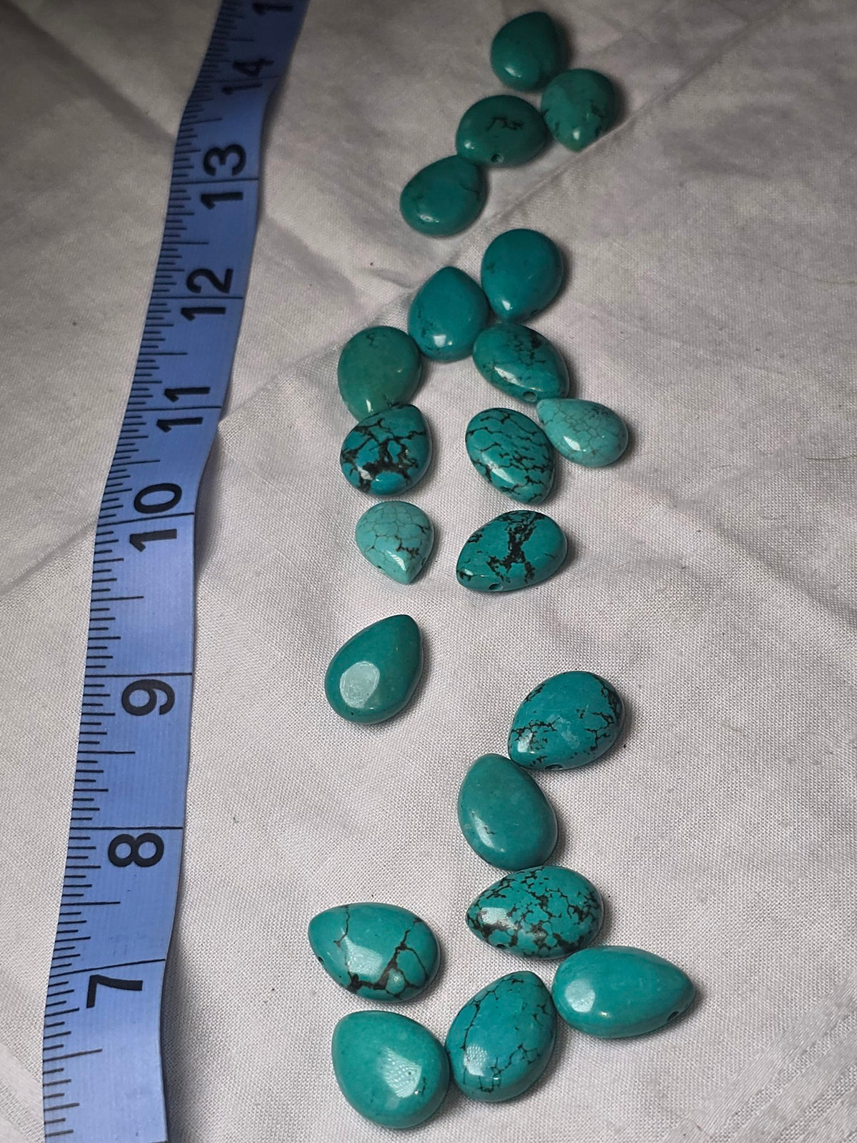 Closeup of turquoise look teardrop beads