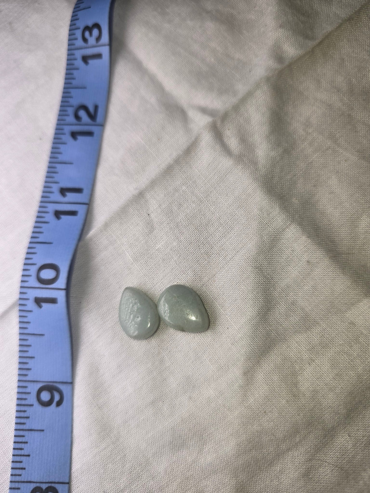 Pale blue teardrop beads with ruler