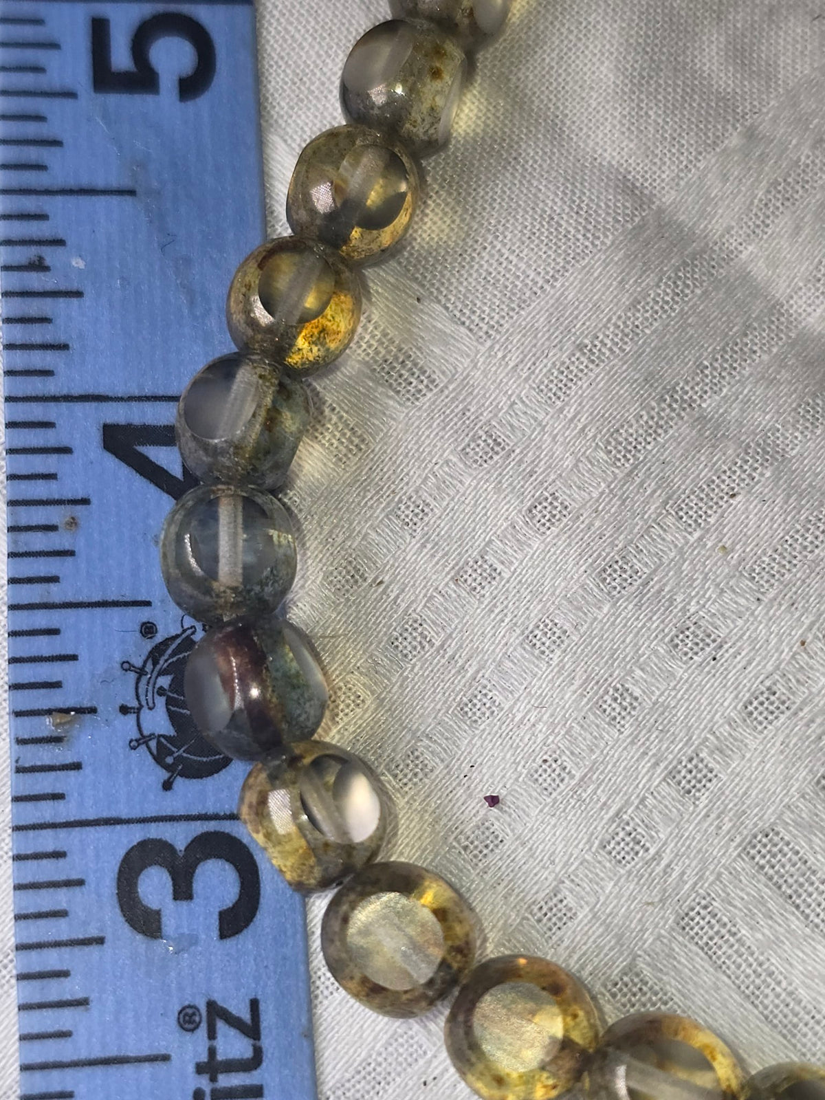 Translucent grey gold round beads closeup