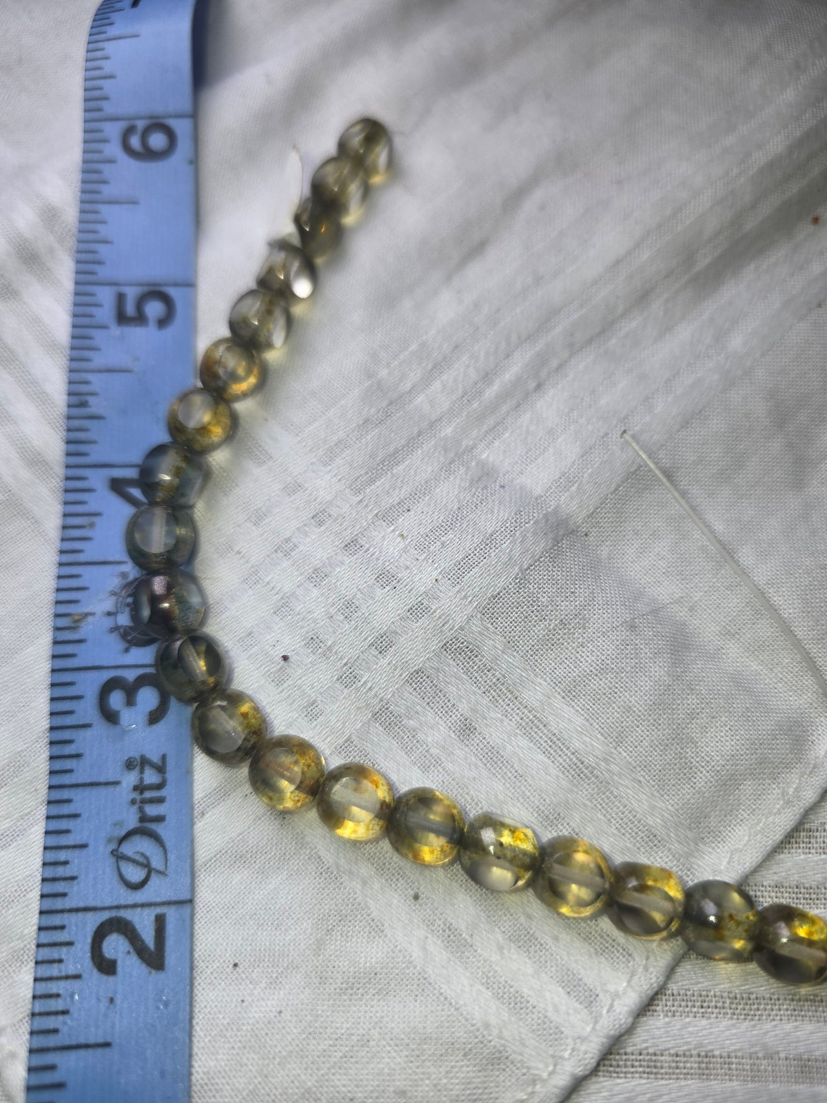 Translucent grey gold round bead strand with ruler