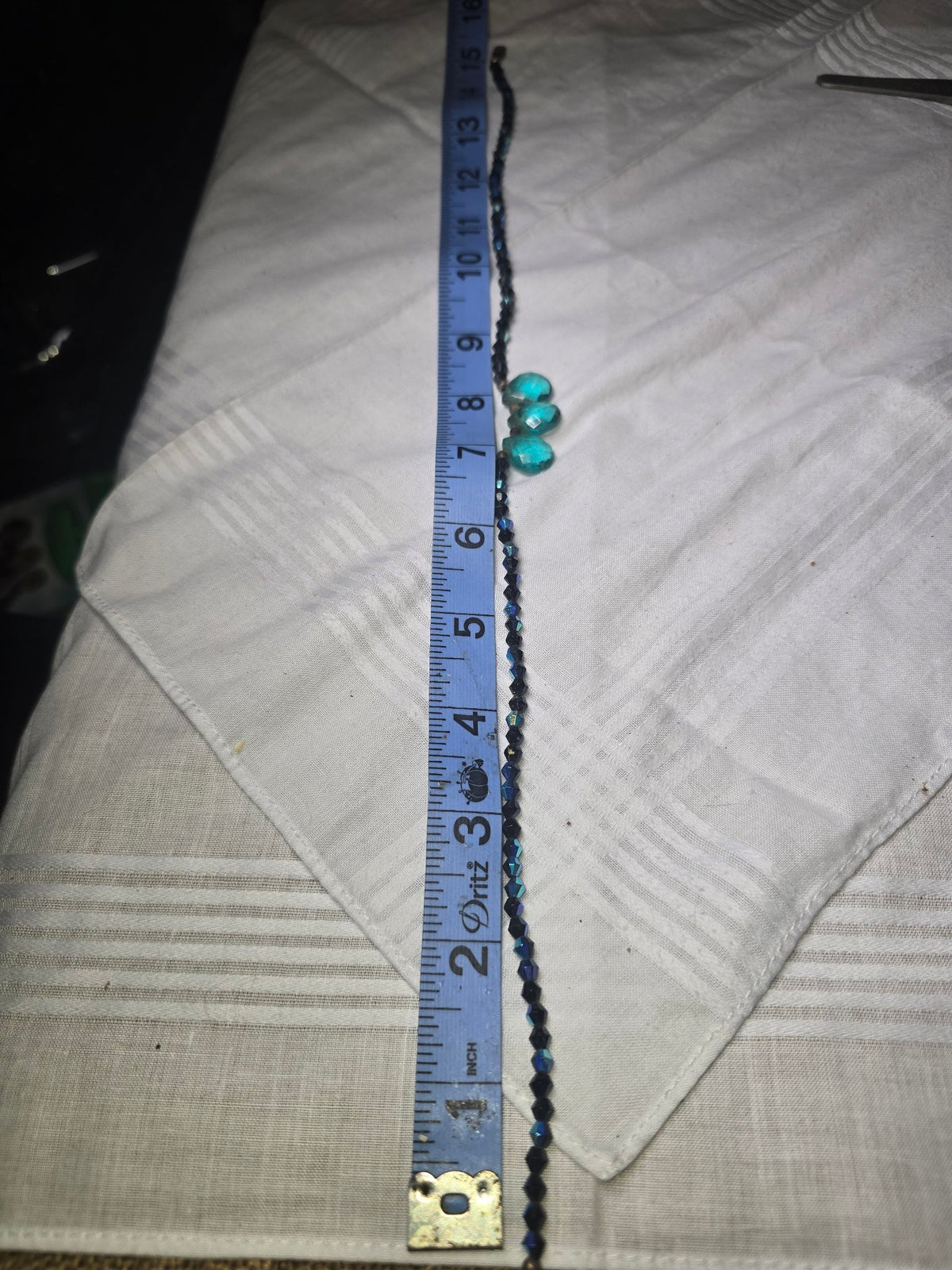 Dark blue bicone bead strand with turquoise teardrop focals and ruler