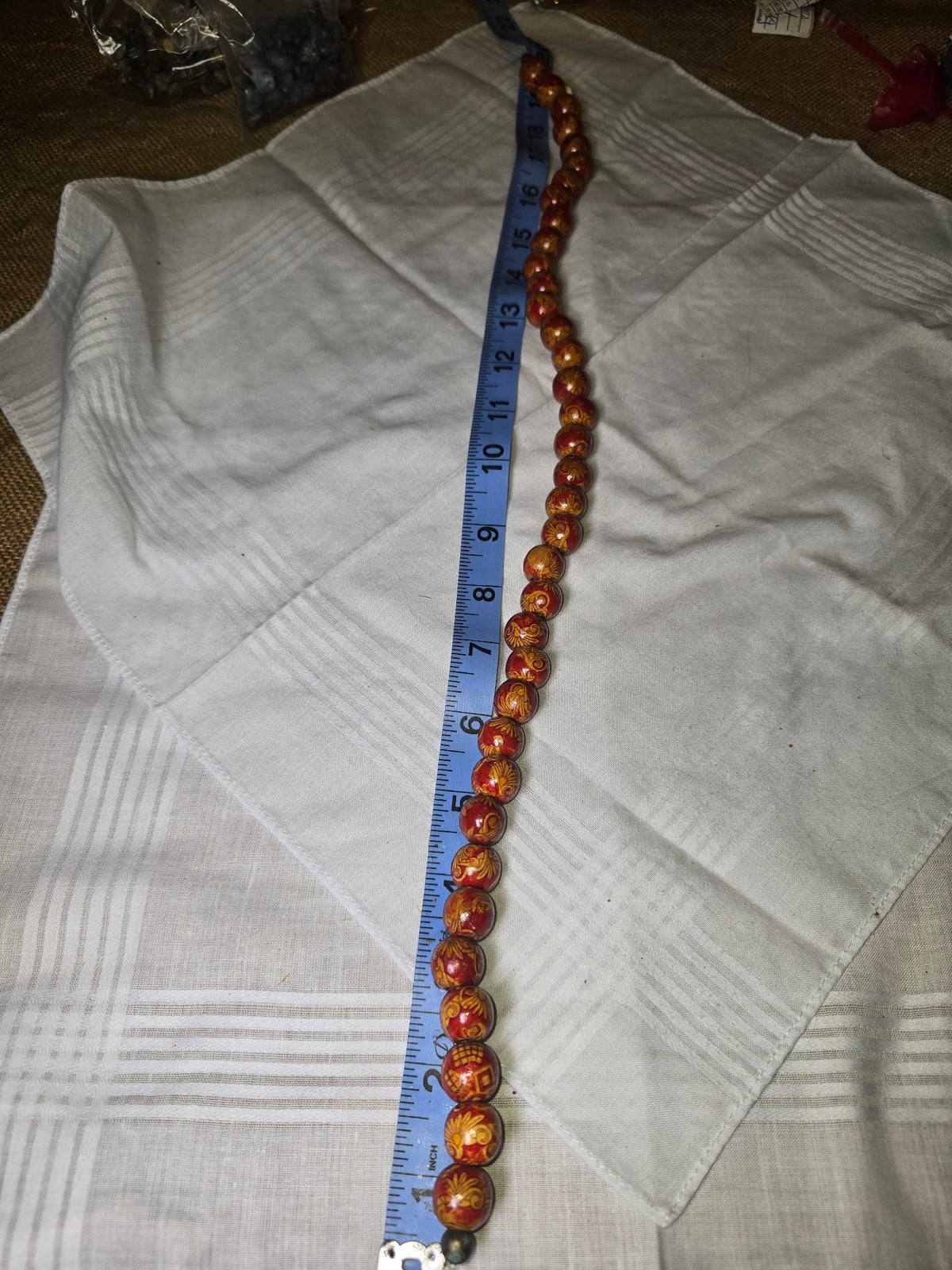 Red painted wood round bead strand with ruler