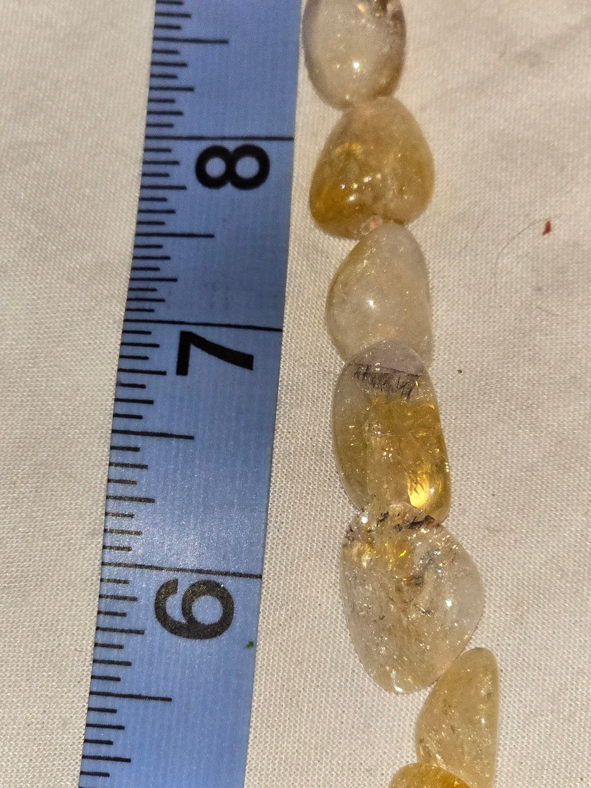 Golden rutilated quartz nugget bead strand closeup