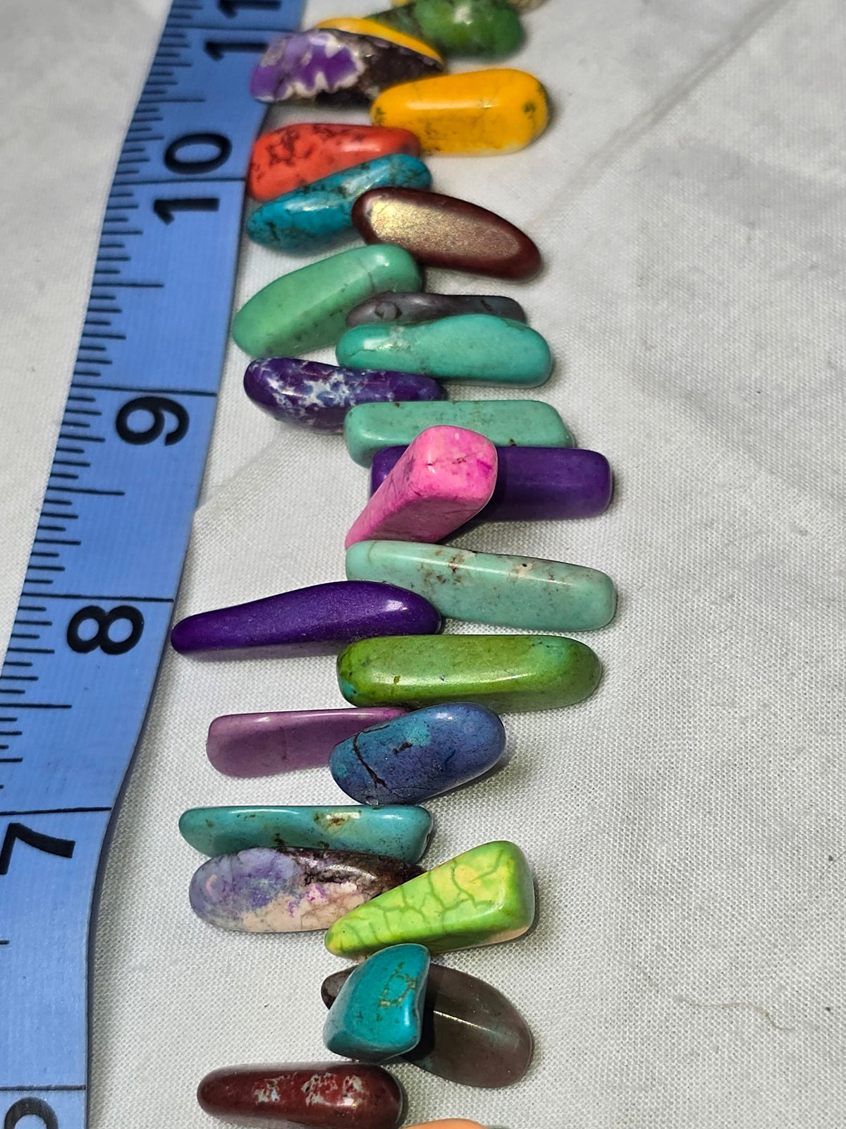 Multicolor dyed howlite stick bead strand closeup