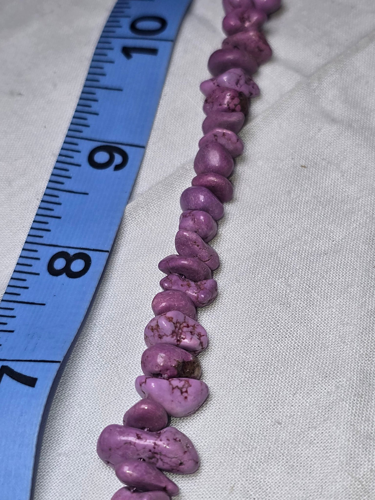 Purple dyed howlite chip bead strand closeup