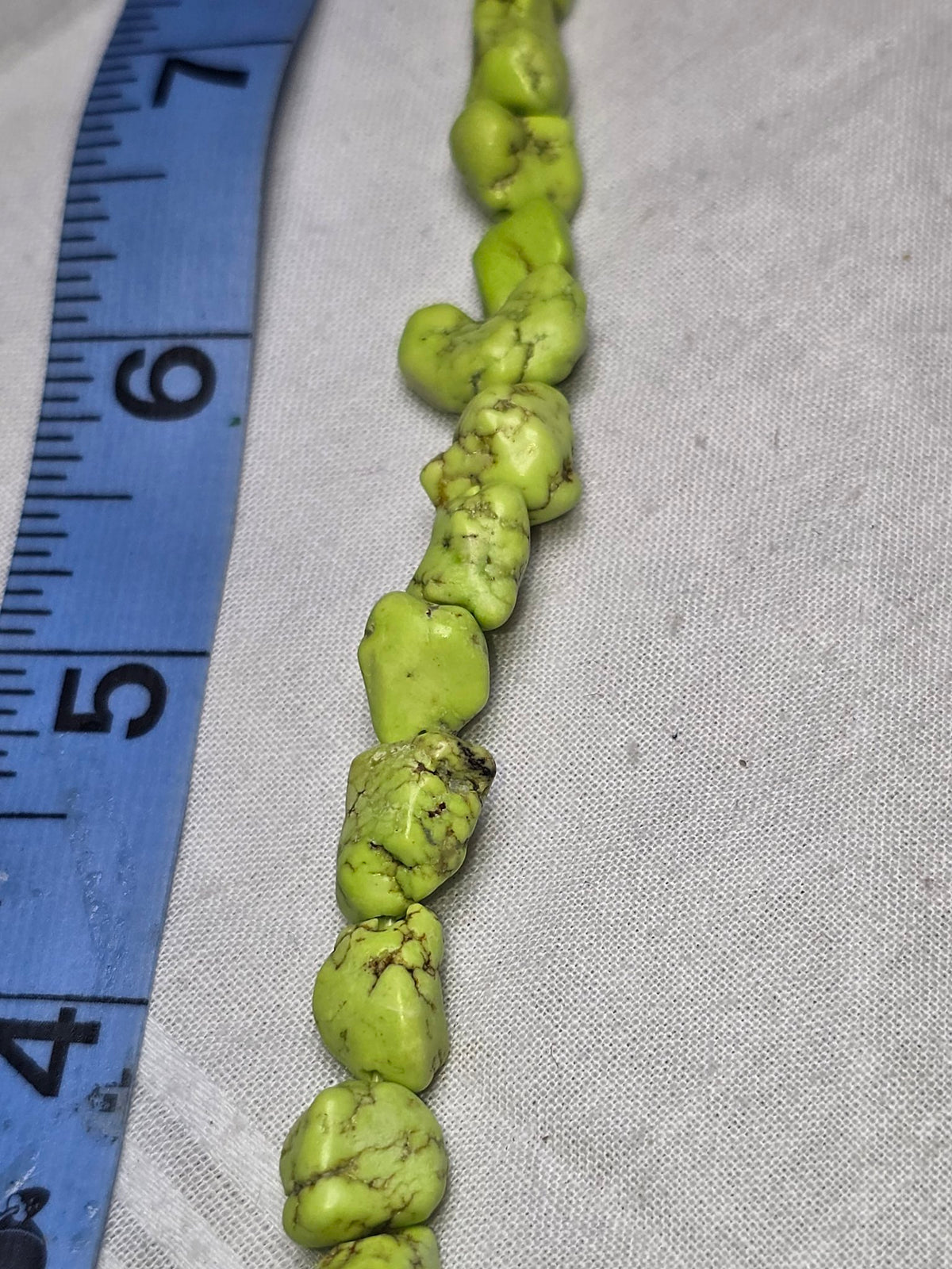 Lime green dyed howlite chip bead strand closeup
