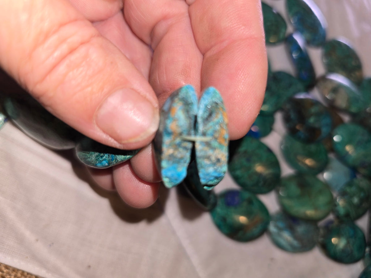 Chrysocolla in lapis flat oval hand closeup