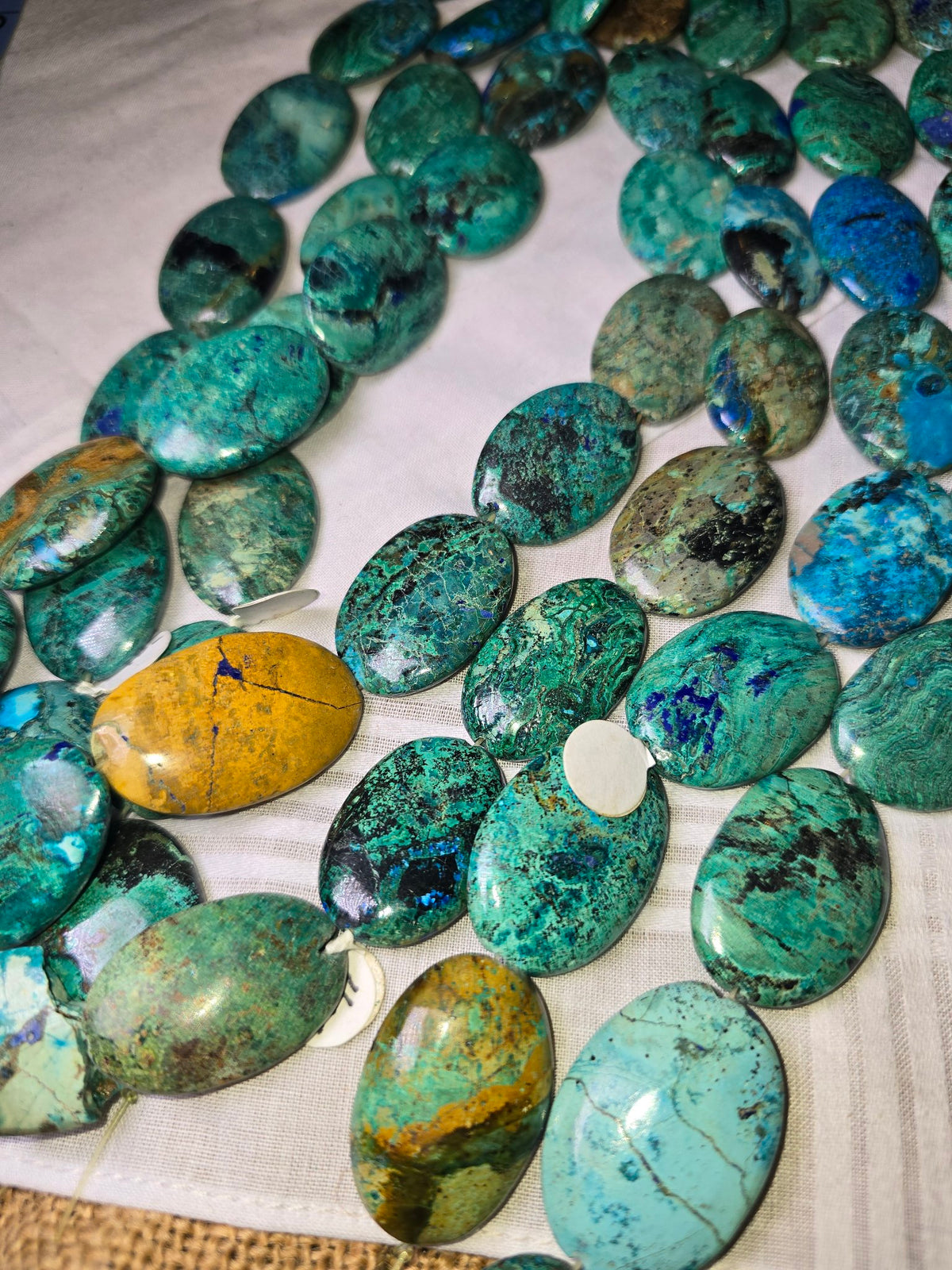 Chrysocolla in lapis flat oval group view