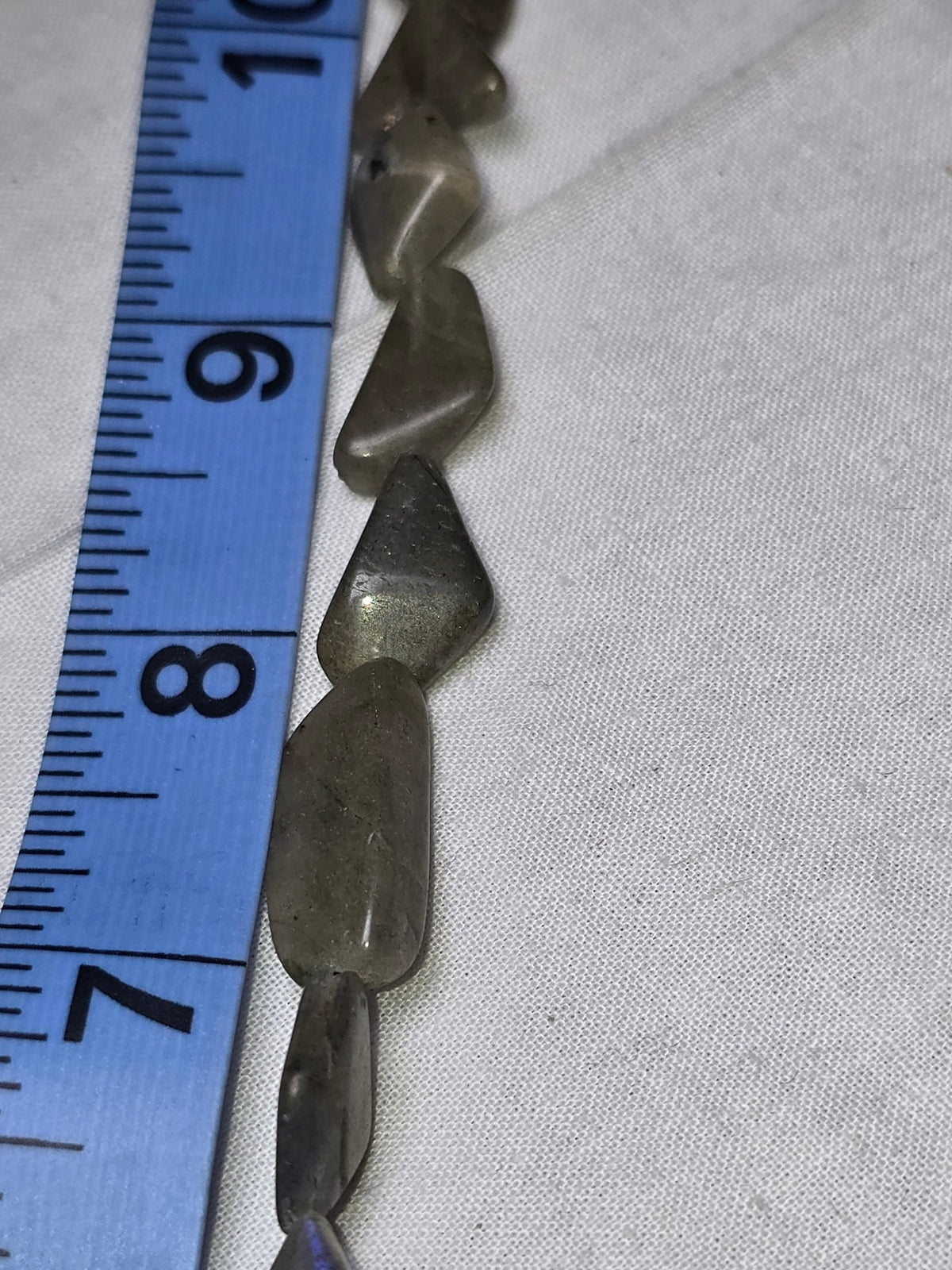 Grey chip bead strand closeup