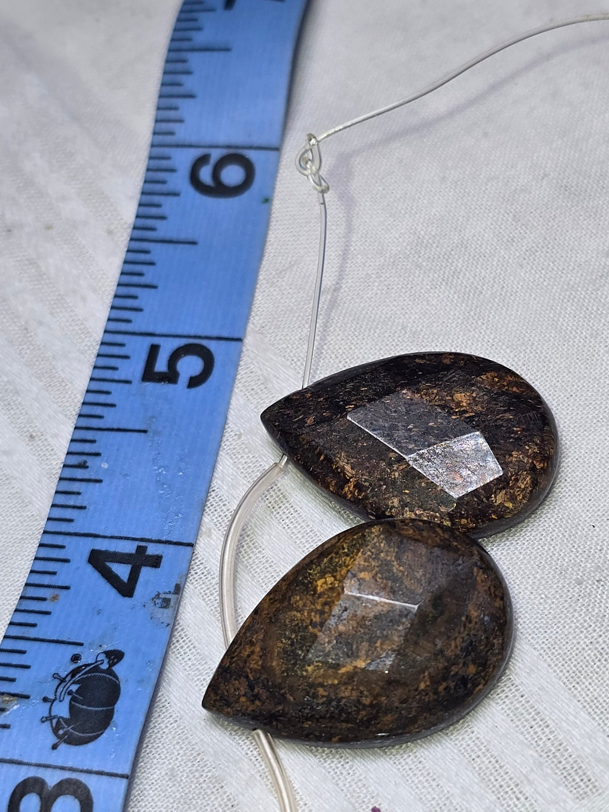 Bronzite faceted teardrop bead closeup