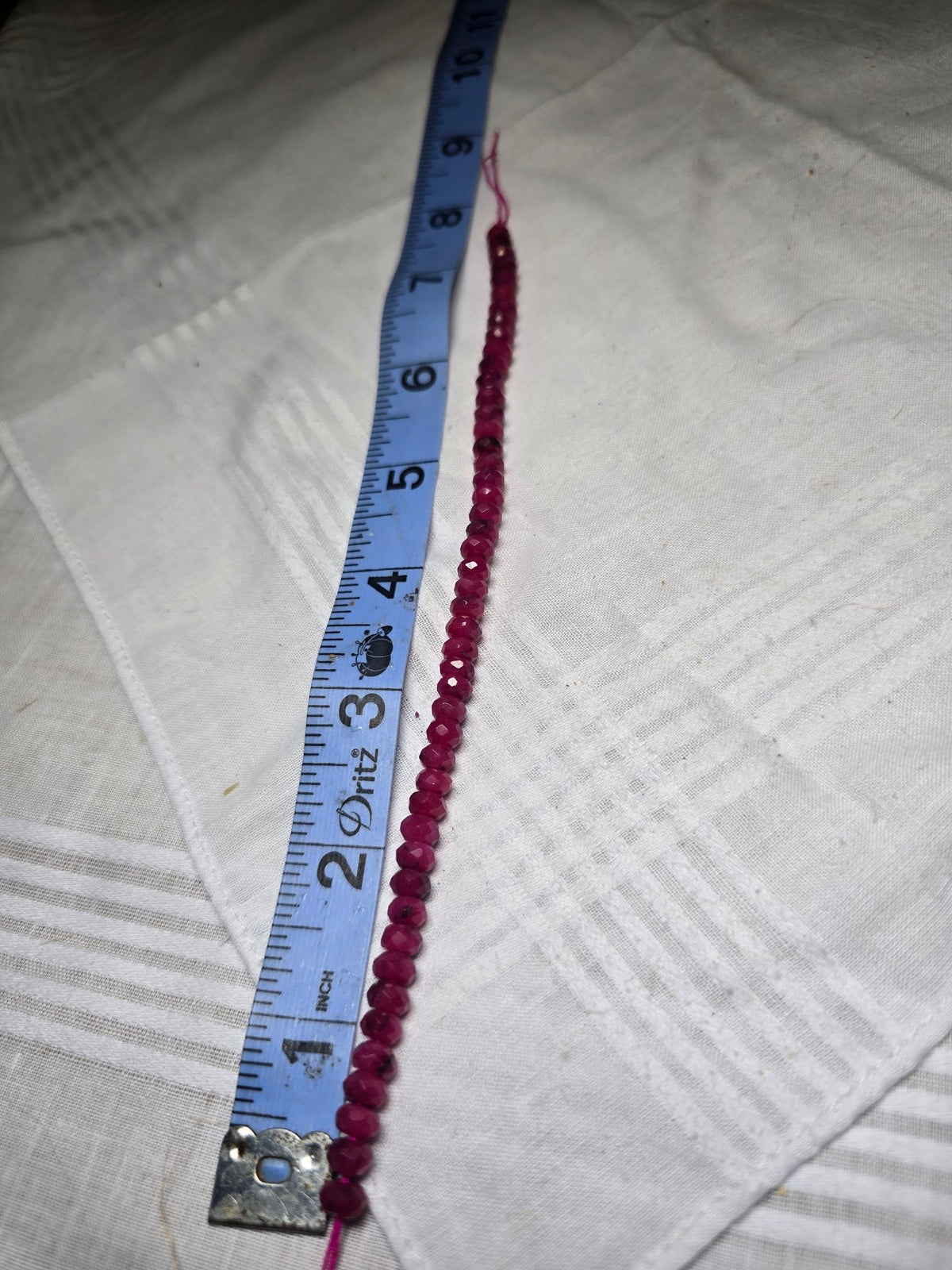 Ruby faceted round bead strand