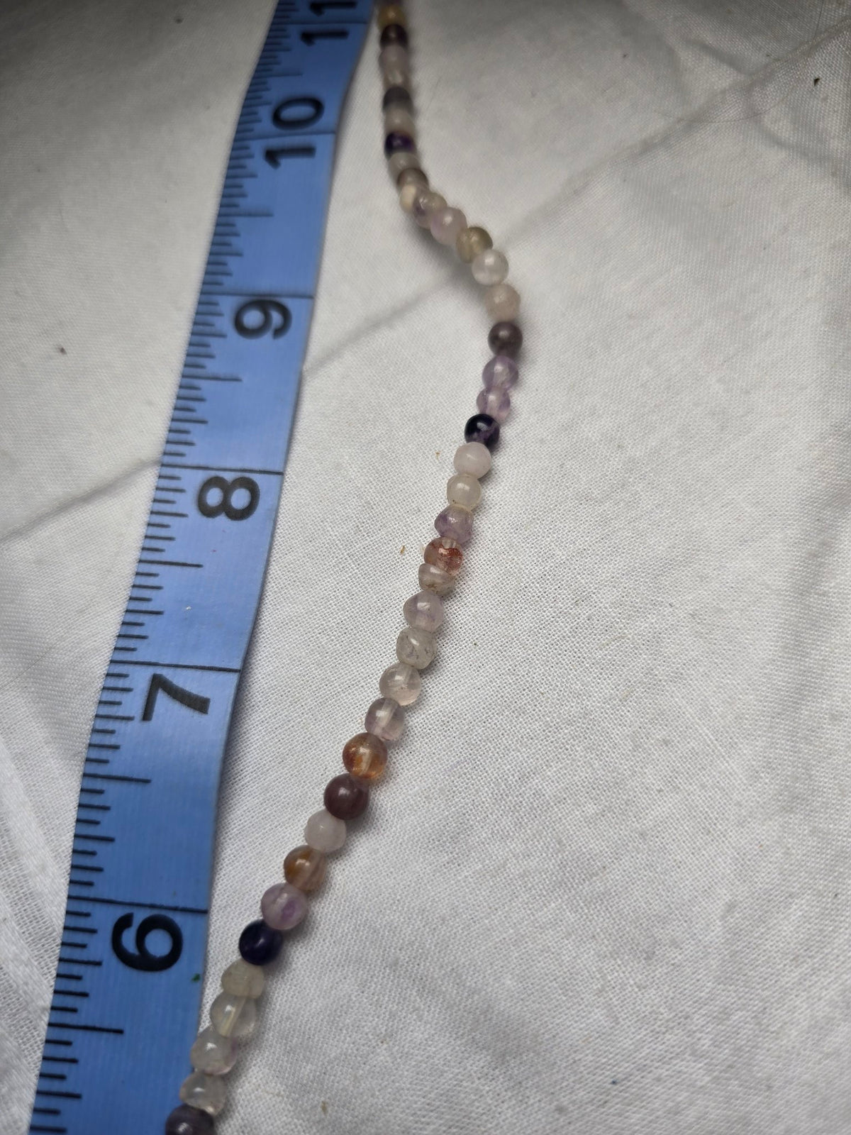 Mixed small round bead strand closeup