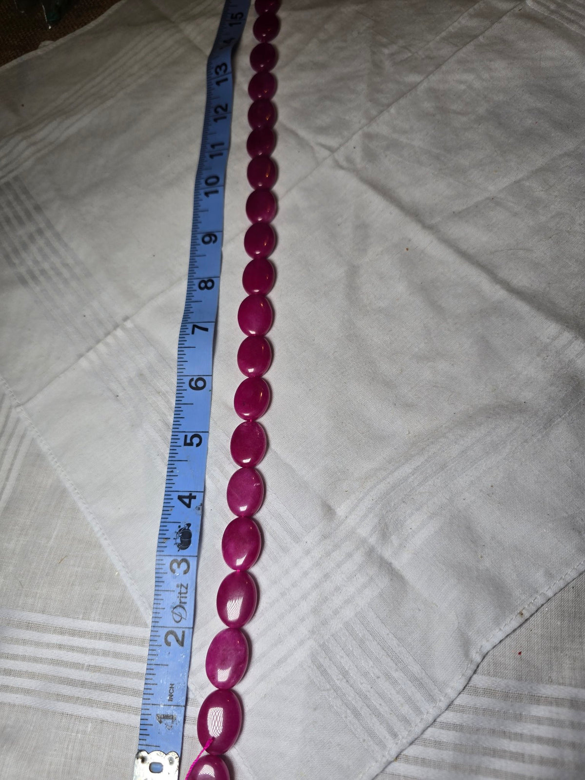 Magenta pink oval bead strand