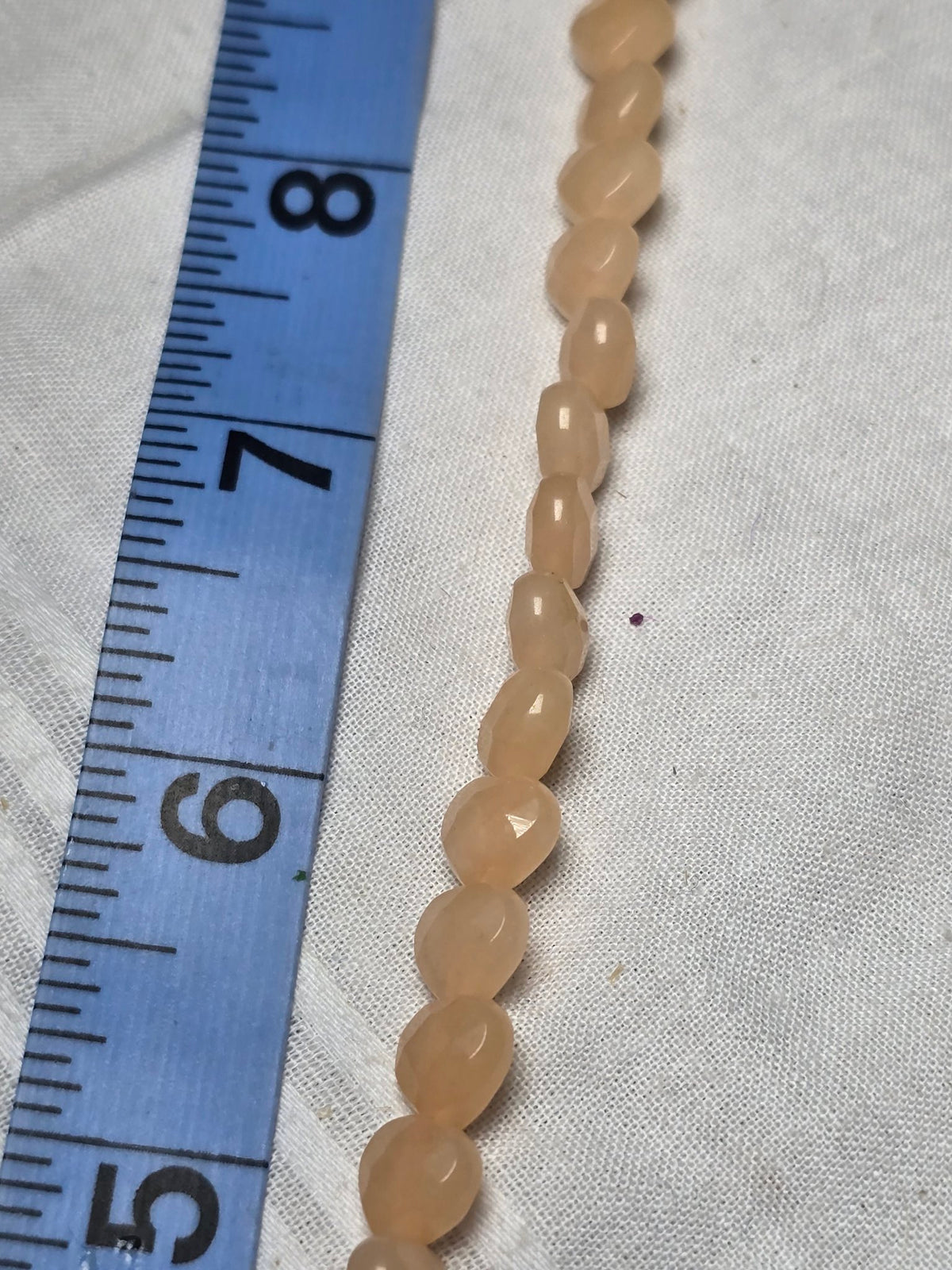Pale peach oval bead strand closeup