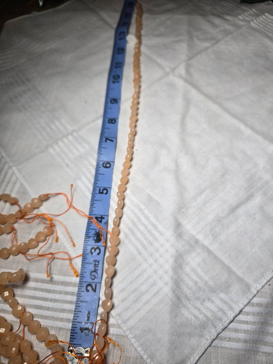 Pale peach oval bead strand
